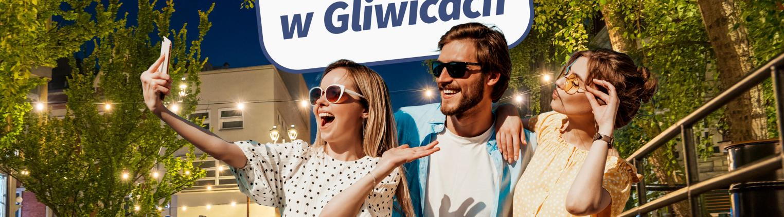 Tzy osoby na oświetlonej Alei Przyjaźni, nad nimi napis: Co robić w weekend w Gliwicach?